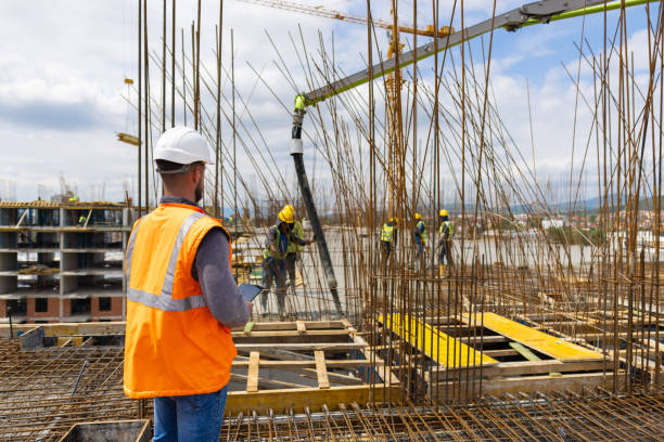 istock Architect, supervise group of construction workers at the construction site 1548127137