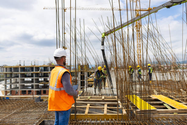istock Building contractor, supervise group of construction workers at the construction site 1548127140