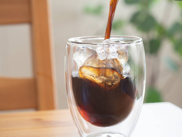 istock Pouring iced coffee into a glass 1548165213