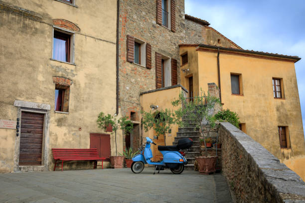 Italian motor scooter parked a dark alley.