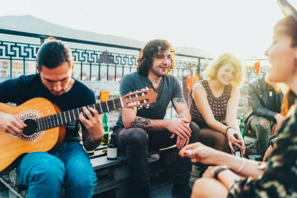 friends drinking and partying on the rooftop - individual event women people autumn imagens e fotografias de stock