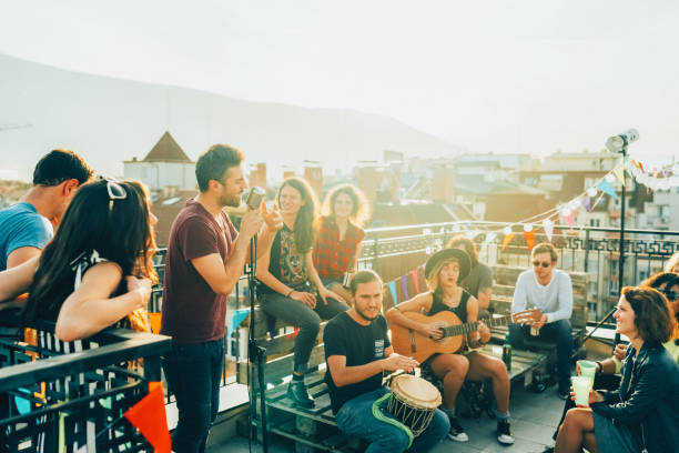 friends drinking and partying on the rooftop - individual event women people autumn imagens e fotografias de stock