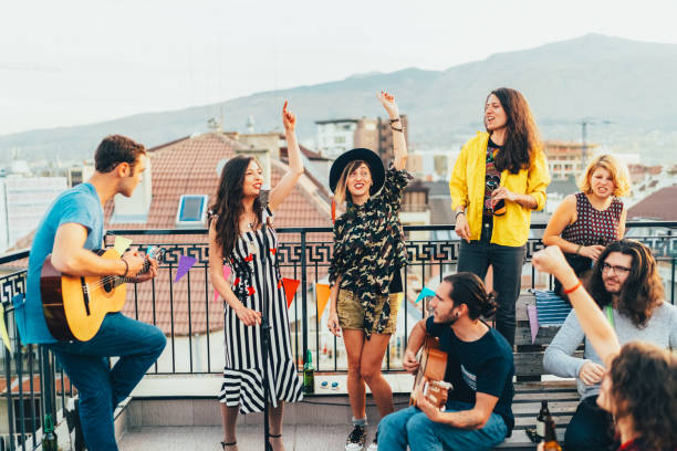 friends drinking and partying on the rooftop - individual event women people autumn imagens e fotografias de stock