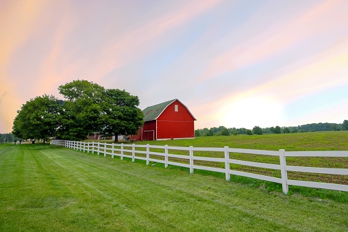Red Barn with white fence at sunrise- Northern Indiana