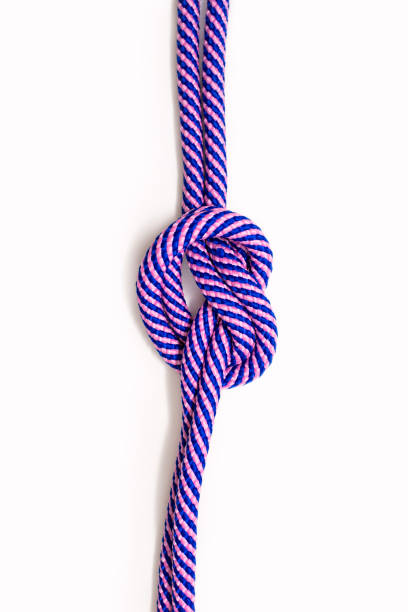 istock Multicolored blue-pink rope with a knot on a white background 1548245605