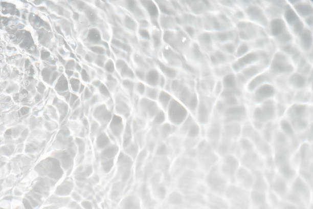 istock White water with ripples on the surface. Defocus blurred transparent white colored clear calm water surface texture with splashes and bubbles. Water waves with shining pattern texture background. 1548247961