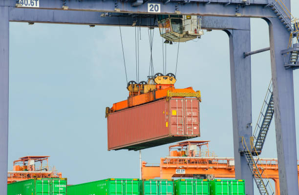 istock When the container terminal at dusk, work cranes and forklift. 1548250286