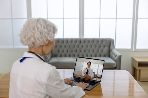 istock Senior doctor discussing with another doctor through web conference 1548279722