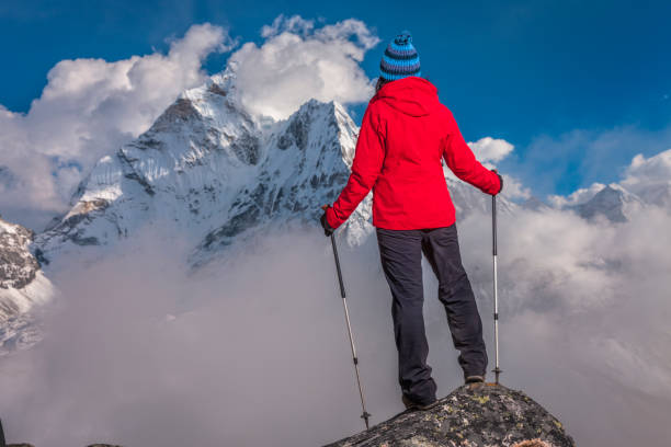 istock Woman watching sunset over Himalayas, Mount Everest National Park 1548282911