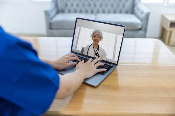 istock Doctor discussing with another doctor through web conference 1548285052
