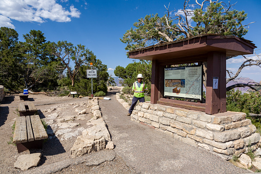 Grand Canyon, USA - July 9, 2008: starting point for the bright angel trail to the button of the grand canyon. A worker controls the trail.The west rim trail is closed.