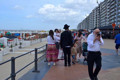 Blankenberge, West-Flanders Belgium - July 16, 2023: uncommon, orthodox jewish family vacationing on the coast
