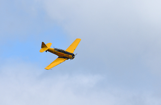 Ickwell, Bedfordshire, England - July 02, 2023: Vintage North American Aviation Harvard T-6 aircraft in yellow navy wings colours.