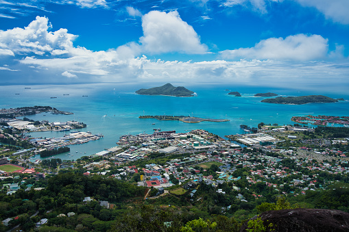 Troise frere nature trail, view of the international port, indian ocean tuna company, the st anne marine park, turqouise water and blue cloudy sky, Mahe Seychelles