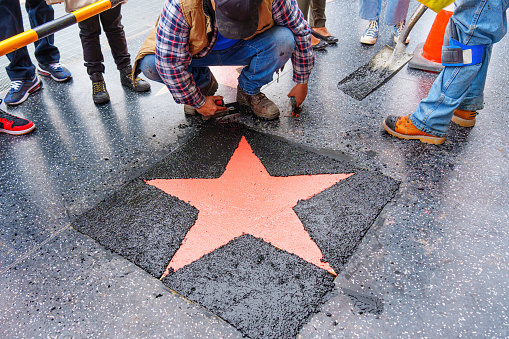 Los Angeles, California - January 3, 2023: Group of tourists observing the installation of a new star on the Hollywood Walk of Fame.