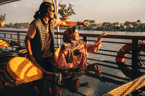portrait of happy  couple  who travels on a boat during sunset on nile river, Cairo