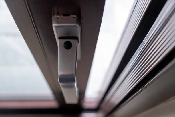 istock Aluminum silver handle on close window with blocking system, blur background. Close up above view. 1548356351