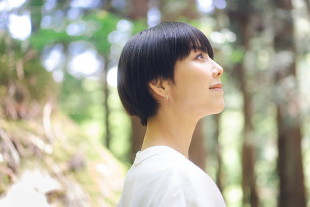 istock Woman walking in the forest. 1548386640