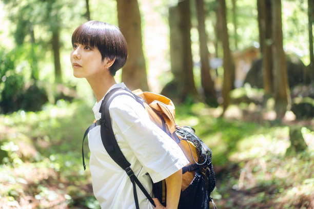 istock Woman walking in the woods. 1548386644