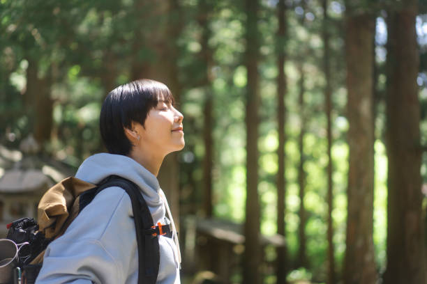 istock Woman walking in the woods. 1548388387