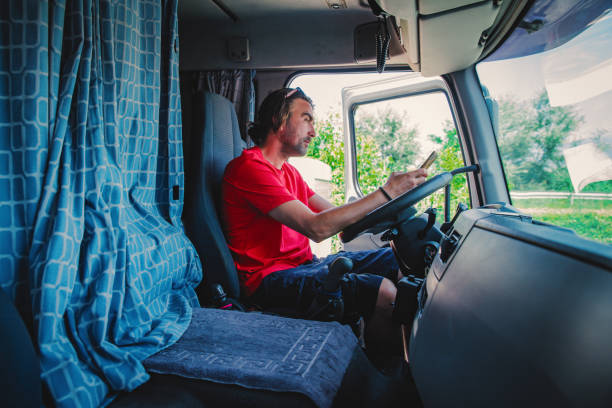 istock Close up of a driver using phone 1548412432