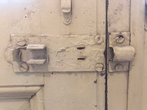 detail of the ironwork of an old wooden door