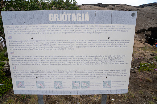 Myvatn, Iceland - July 4, 2023: Sign board with information on the Grjotagja Cave, a former bathing spot in northern Iceland