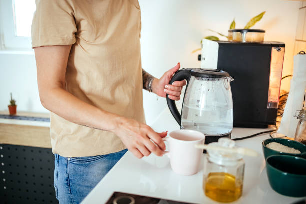 istock Woman prepares tea in the kitchen 1548469944