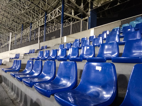 Rows of plastic seats at a stadium. Landscape picture at stadium.