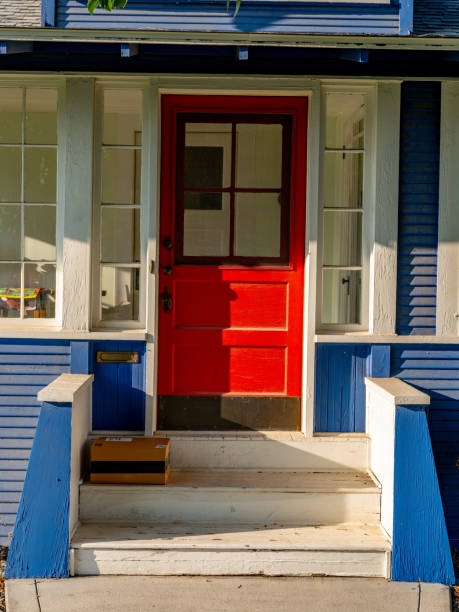 istock Front steps of a house with a package delivery 1548584117