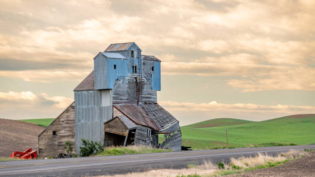 Dilapidated old grain elevator with barn on top