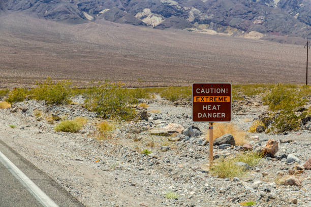 Warning sign caution extreme heat, danger in hot Death Valley National Park, USA stock photo