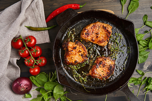 Beautifully done tenderloin steak in a cast iron skillet, flat lay shot from above