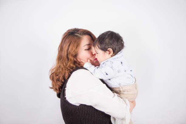 istock loving mom with baby on light photo studio 1548665094