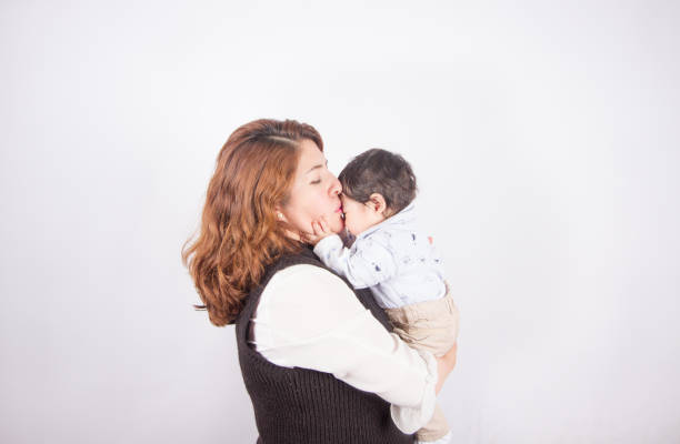 istock loving mom with baby on light photo studio 1548665097