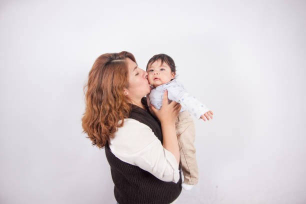istock loving mom with baby on light photo studio 1548665654