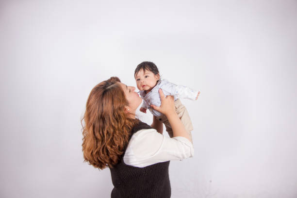 istock loving mom with baby on light photo studio 1548666161