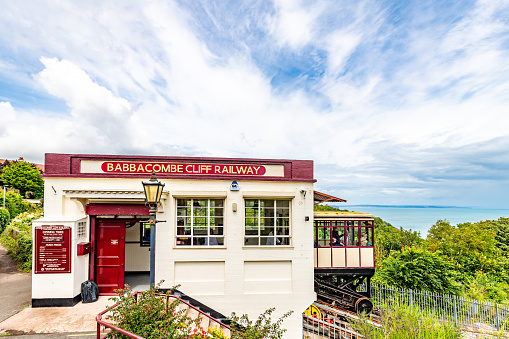 Torquay, UK. 16 July 2023. The historic Babbacombe Cliff Railway takes passengers between the cliff top to the beach. The top station is at Babbacombe