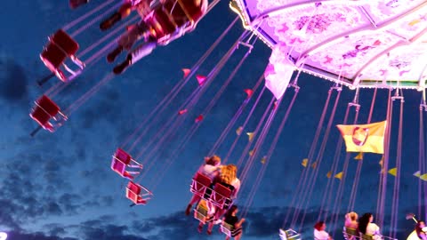 On the merry-go-round. Happiness. Twilight. Lights. Flight through the air.