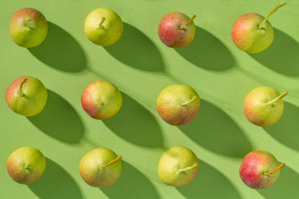 istock Pears pattern fruits arrangement in a row, minimal flat lay green background 1548782304