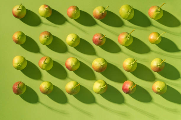 istock Pears pattern fruits arrangement in a row, minimal flat lay green background 1548783338