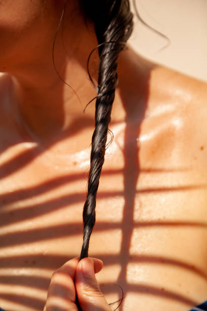 istock Wet braid of dark hair against bare shoulder 1548811605