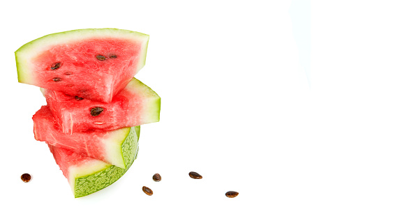 Slices of watermelon isolated on a white background. Free space for text. Wide photo.
