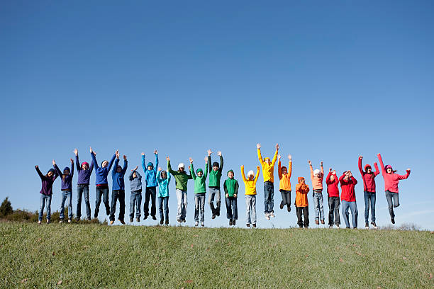 istock Real People: Large Group Multi-Racial Children Jumping Together Outdoors Diversity 154882433
