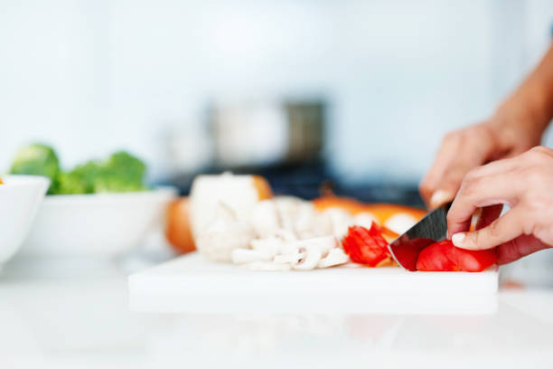 istock Closeup of hands chopping vegetables in the kitchen 154882621
