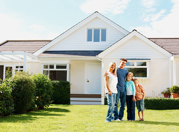 Caucasian family standing in front of a luxury house Full length of a Caucasian family standing in front of a luxury house in front of stock pictures, royalty-free photos & images