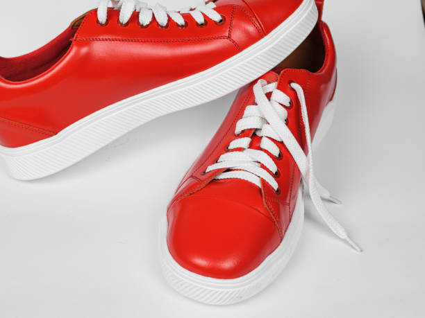 istock Red leather sneakers with white soles and white laces 1548837341