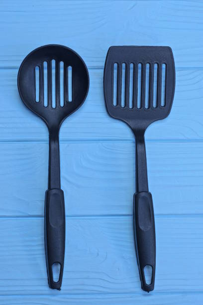 istock plastic kitchen utensils lie on a blue wooden table 1548837347