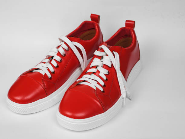 istock Red leather sneakers with white soles and white laces 1548837403