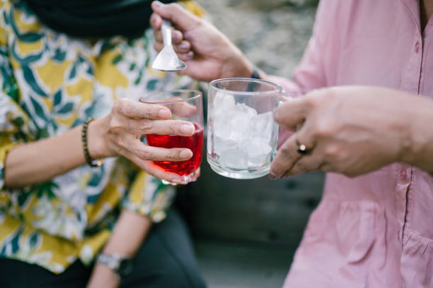 Celebration event close-up of hand holding glass. Senior Retirement Friends Happiness